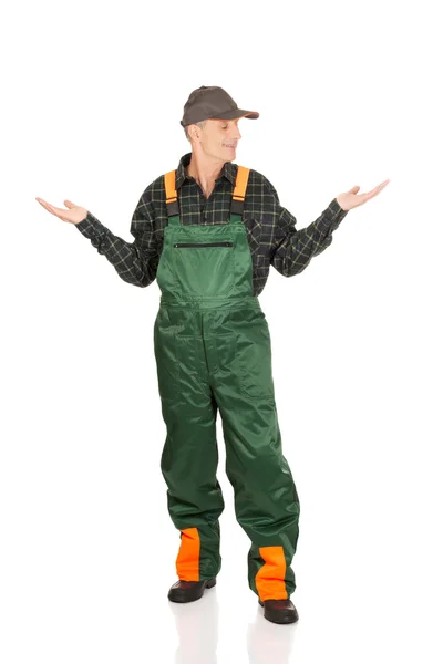 Gardener showing space with both hands — Stock Photo, Image