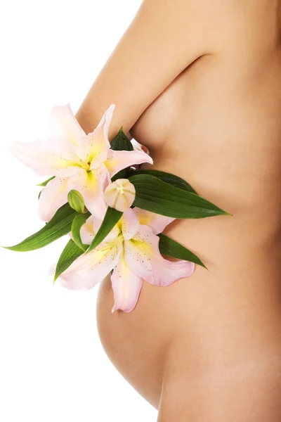 Pregnant woman holding a lily flower — Stock Photo, Image