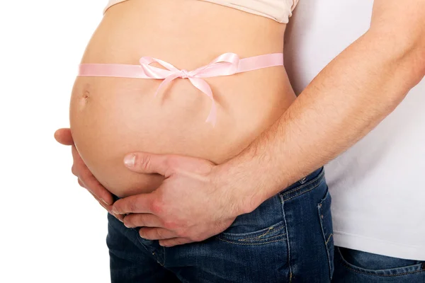 Pregnant woman's belly embracing by parents — Stock Photo, Image