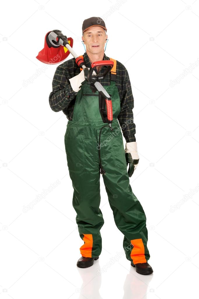 Gardener with trimmer and ear protectors