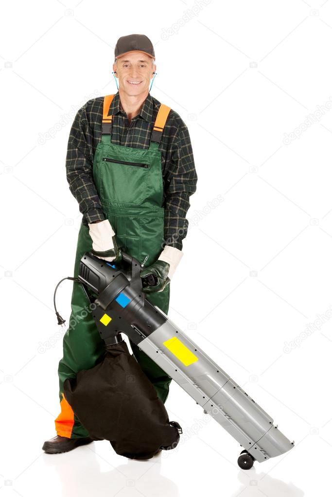 Worker in uniform with a leaf blower