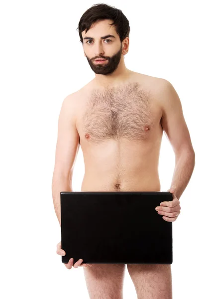 Shirtless man bedrijf laptop. — Stockfoto