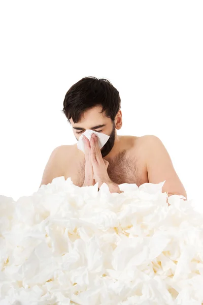 Sick man sneezing into handkerchief. — Stock Photo, Image