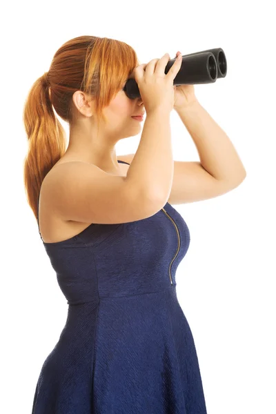 Fat woman looking through binoculars — Stock Photo, Image