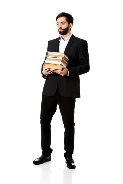 Zakenman bedrijf stapel boeken. — Stockfoto