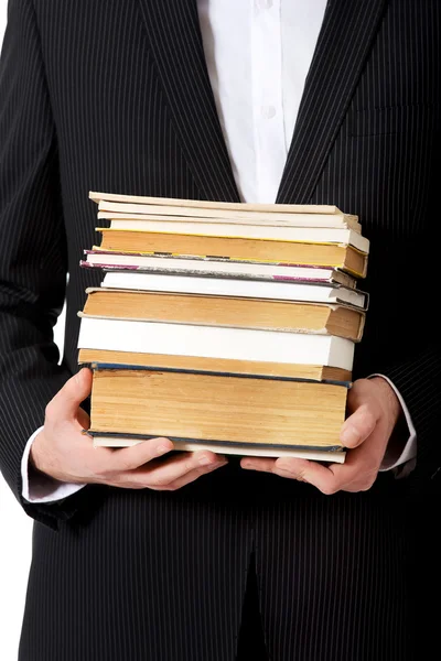 Homme d'affaires tenant une pile de livres . — Photo