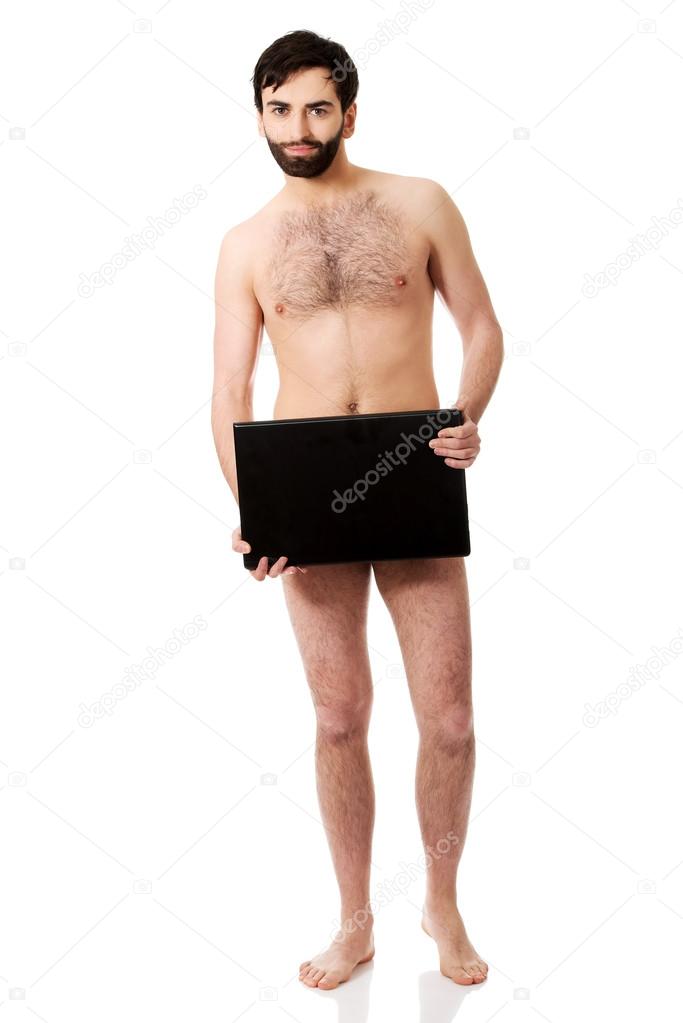 Shirtless man holding laptop.