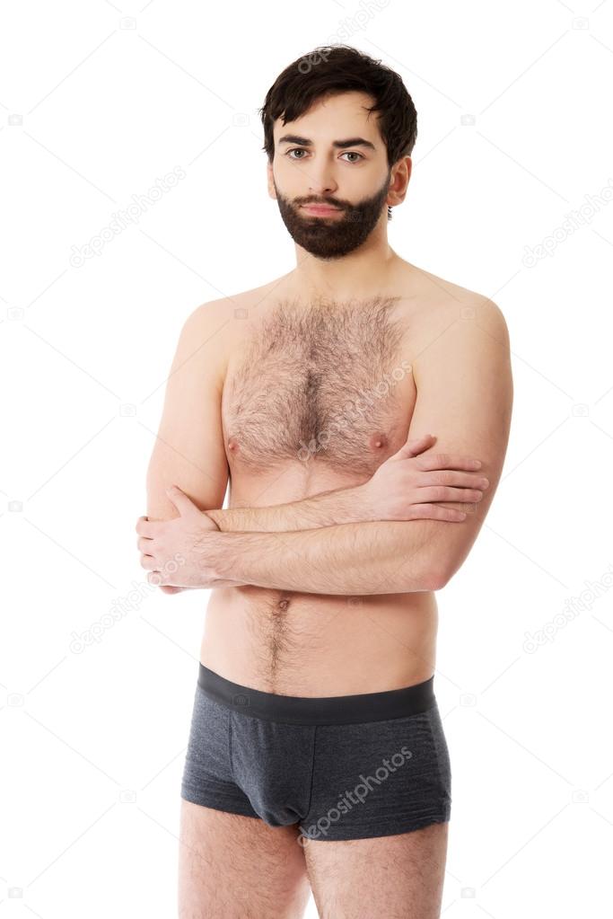 Shirtless man with folded arms.