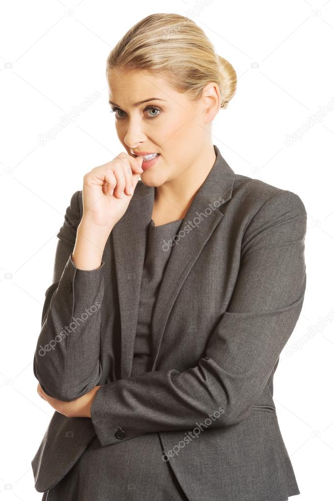 Young woman biting her nails