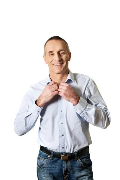 Handsome man buttoning his shirt — Stock Photo, Image