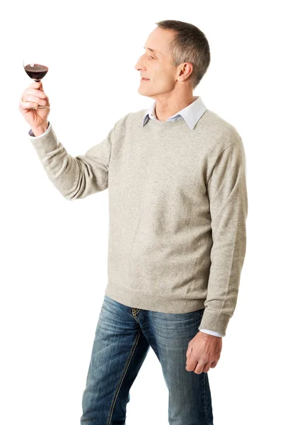 Mature man tasting red wine — Stock Photo, Image