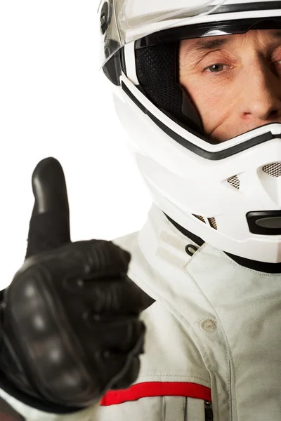 Homem em traje de motorista com sinal de polegar para cima — Fotografia de Stock