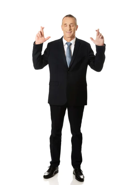 Businessman with fingers crossed — Stock Photo, Image