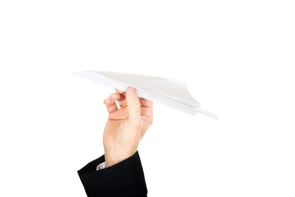 Mano masculina lanzando un avión de papel — Foto de Stock