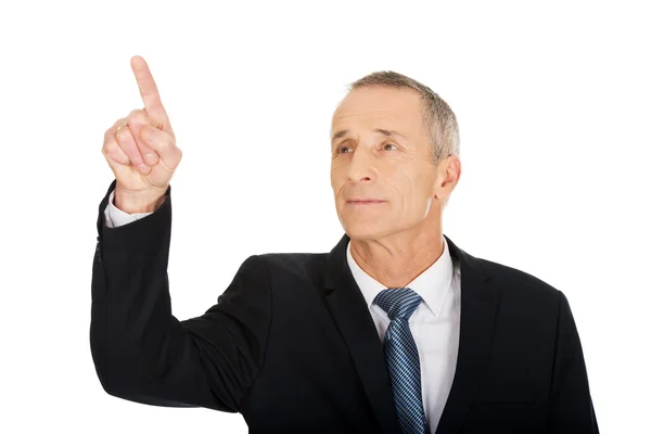 Businessman pressing an abstract button — Stock Photo, Image