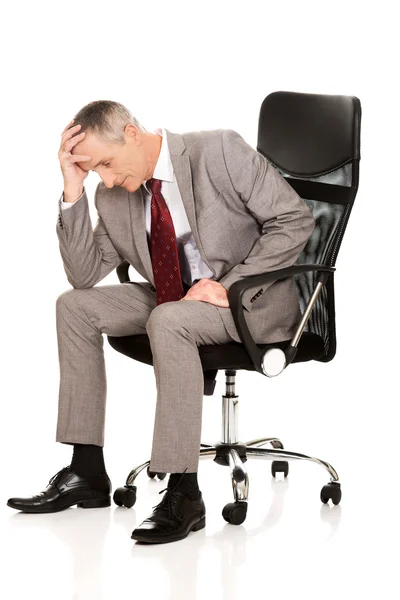 Stressed businessman on armchair — Stock Photo, Image