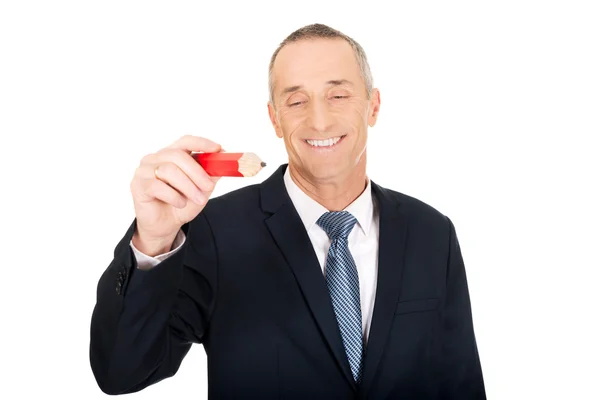 Manager writing with an oversized red pencil — Stock Photo, Image