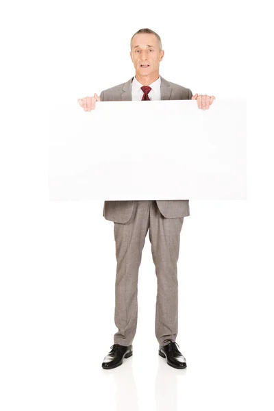 Businessman holding empty banner — Stock Photo, Image
