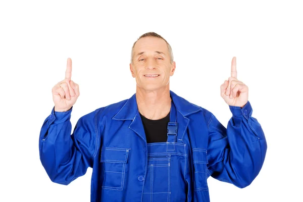 Repairman pointing up with both hands — Stock Photo, Image