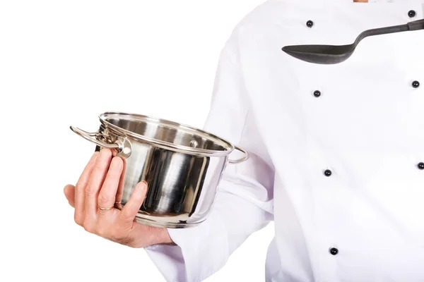 Kockens hand med rostfritt stål pott och sked — Stockfoto