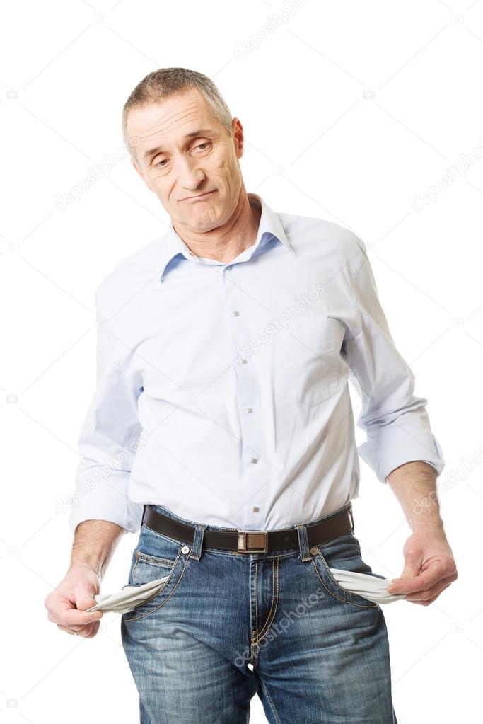 Confused man showing his empty pockets