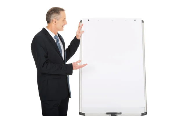 Businessman presenting on flip chart — Stock Photo, Image