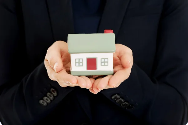 Businesswoman holding house model. — Stock Photo, Image