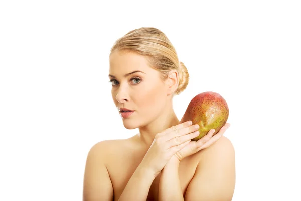 Nude woman holding a mango — Stock Photo, Image