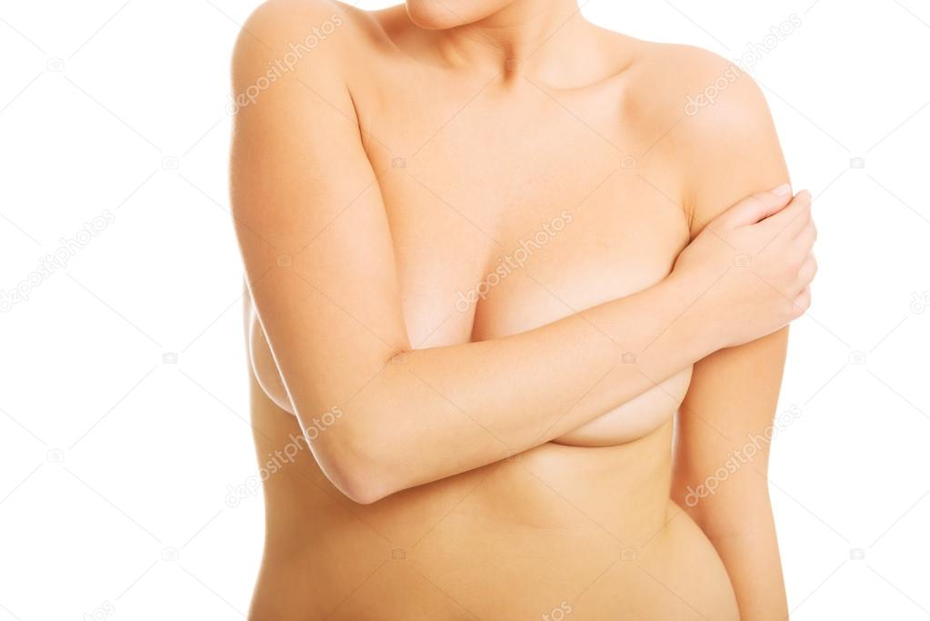 Topless woman covering her breast