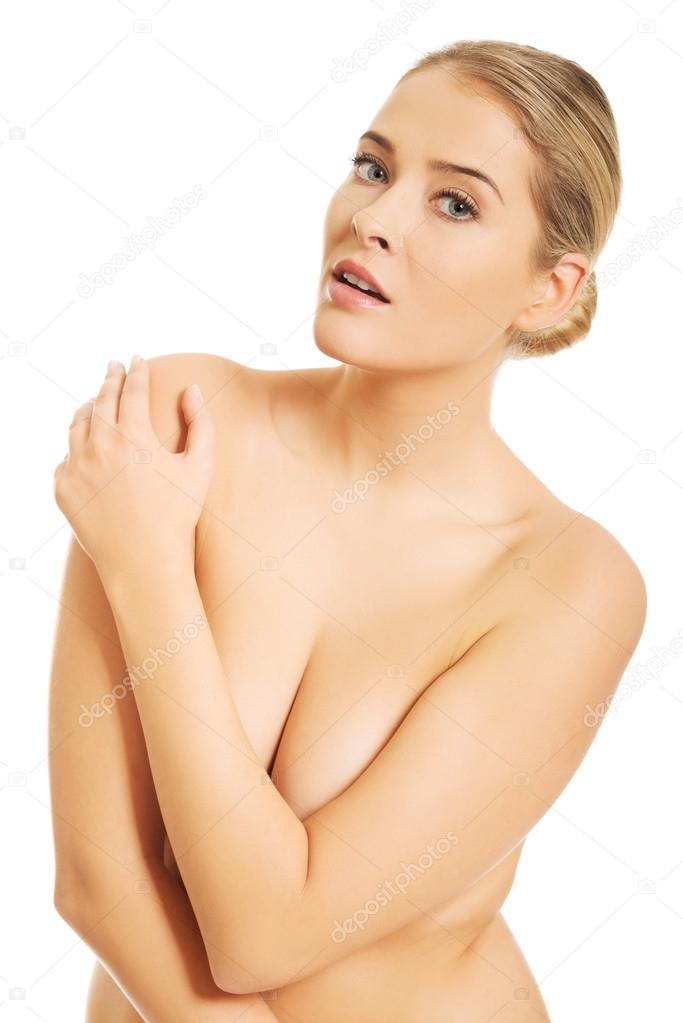 Nude woman covering her breast