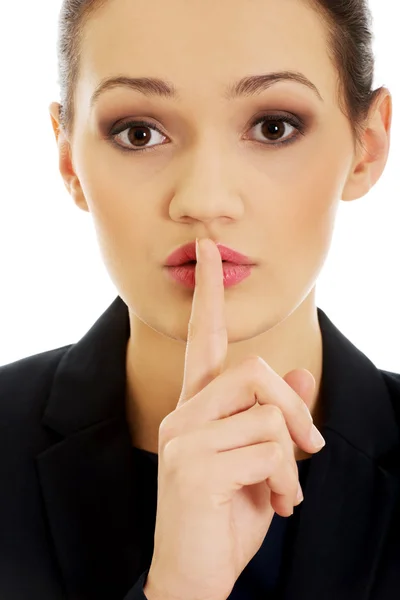 Businesswoman with her finger on lips. — Stock Photo, Image