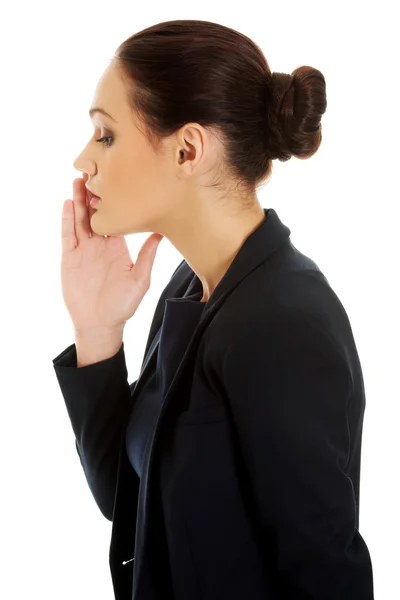 Businesswoman whispering to someone. — Stock Photo, Image