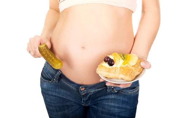 Pregnant woman with cake and pickle — Stock Photo, Image