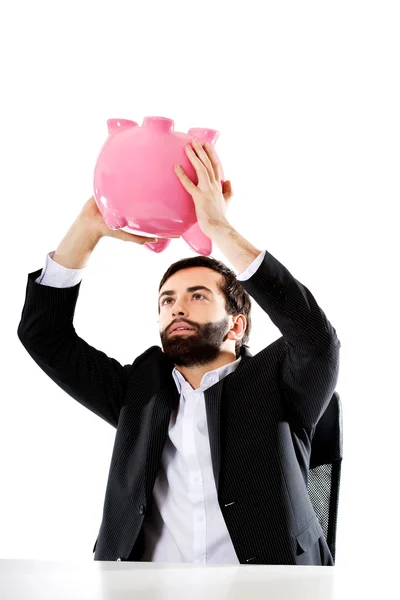 Businessman searching money in piggybank. — Stock Photo, Image