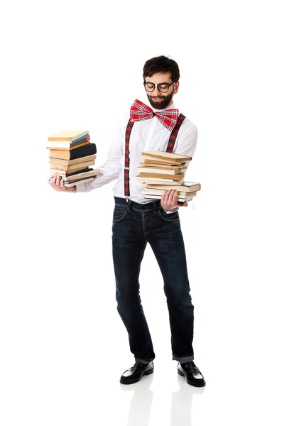 Uomo con pila di libri . — Foto Stock