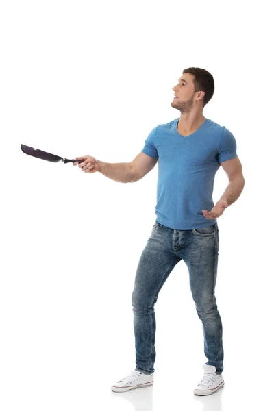 Muscular man holding frying pan. — Stock Photo, Image