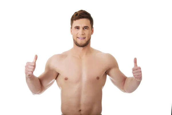 Muscular man showing thumbs up. — Stock Photo, Image