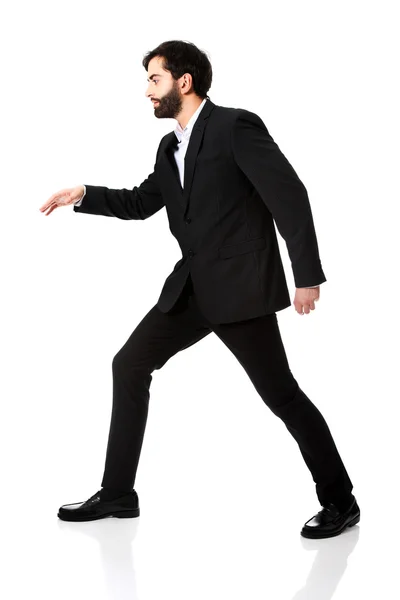 Businessman walking carefully. Stock Picture