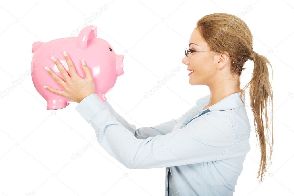 Woman holding piggy bank.