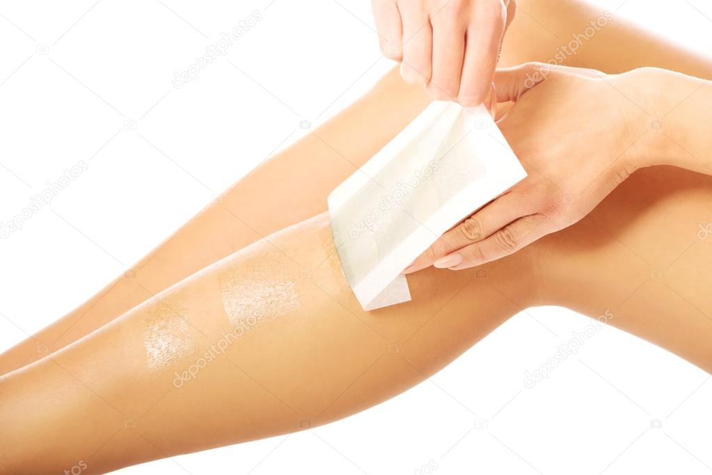 Woman waxing her leg