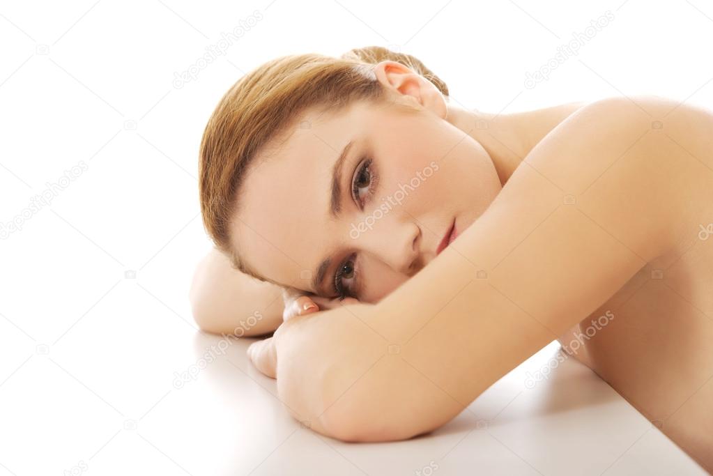 Spa woman resting her head on desk.