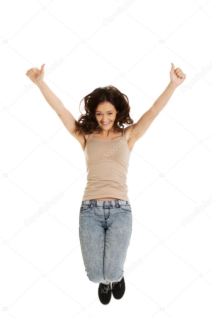 Woman  jumping with thumbs up