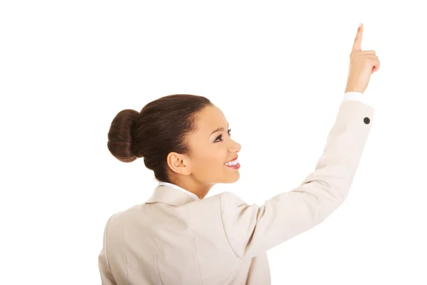 Happy businesswoman pointing up. — Stock Photo, Image