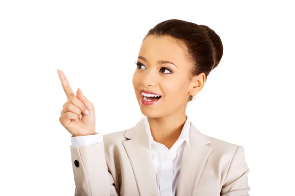 Happy businesswoman pointing up. — Stock Photo, Image