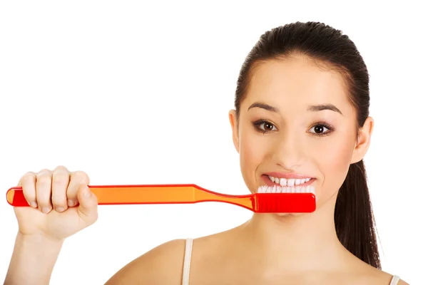 Mujer joven cepillándose los dientes. — Foto de Stock