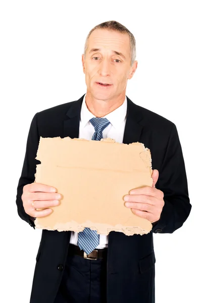 Podnikatel drží kus lepenky — Stock fotografie