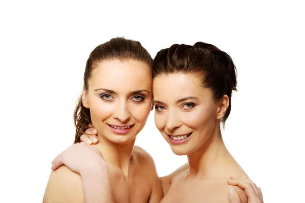 Two sisters with make up embracing. — Stock Photo, Image