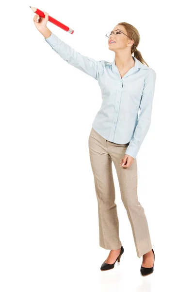 Businesswoman writing with big pencil. — Stock Photo, Image