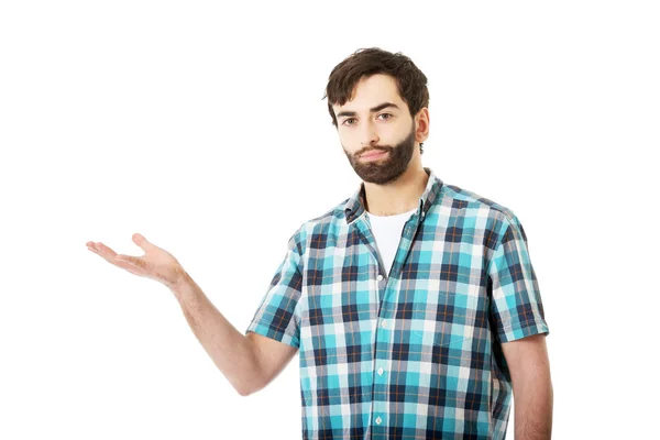 Young man showing something on palm. — Stock Photo, Image