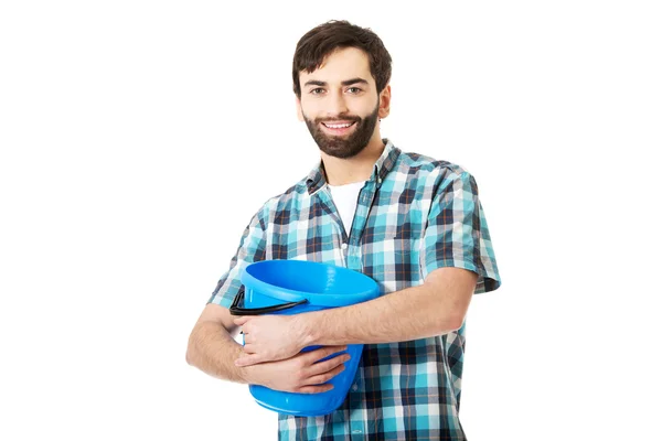 Handsome man holding plastic bucket. — Stock Photo, Image